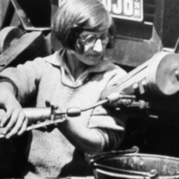 1920s black and white photo of a woman working with equipment