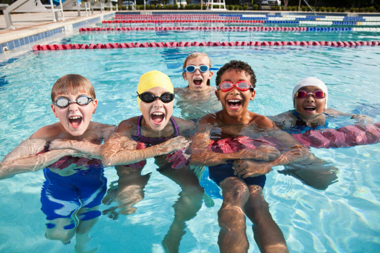 Group of multi-ethnic children having fun in swimming pool.