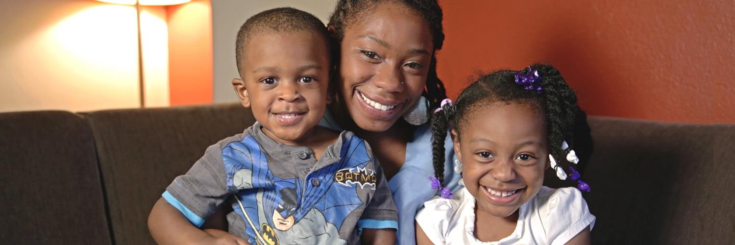 J'Nae and her children smiling at camera