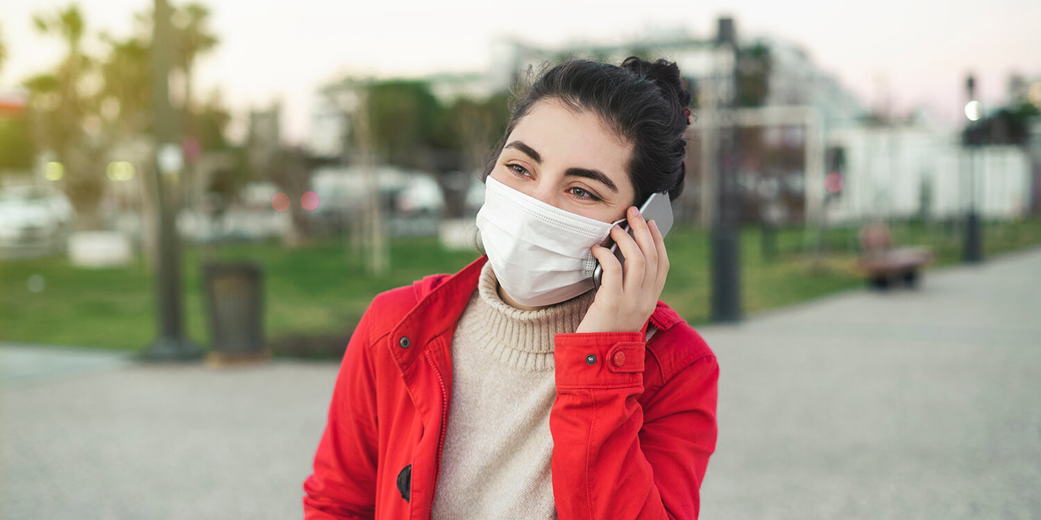 woman talking on the phone with face protective mask