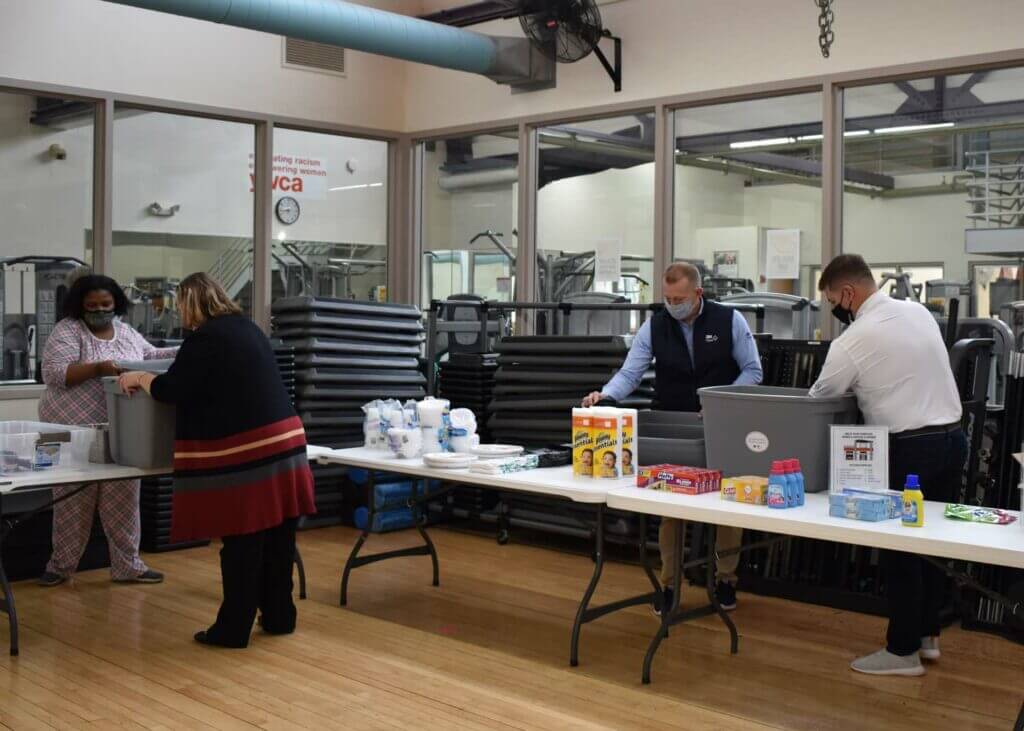 Volunteers stocking welcome baskets